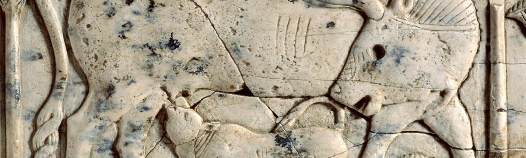 Ivory plaque of a cow and calf among papyrus plants