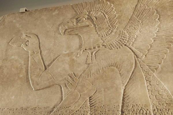 Stone slab carved with a bird-headed spirit from the Northwest Palace at Nimrud, capital of Assyria