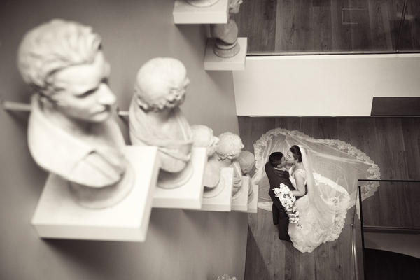 Wedding couple on staircase descending into the atrium