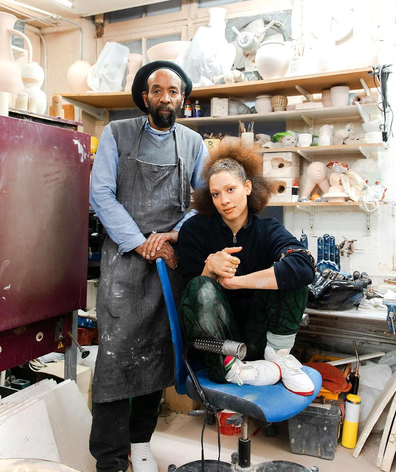 Ceramicists Chris Bramble & daughter Freya in their studio surrounded by pots