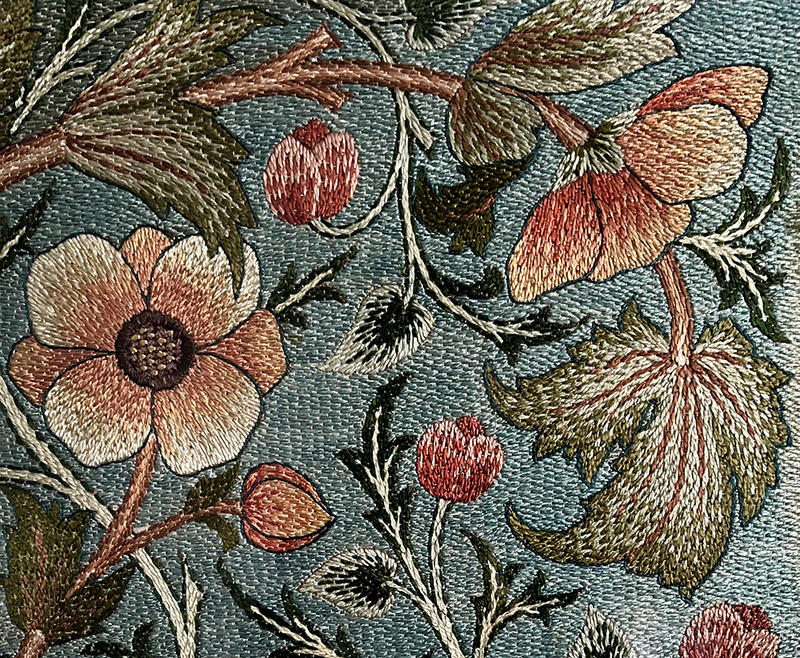 Pretty anemone embroidered screen panel in pinks, oranges, blues and greens, stitched by May Morris