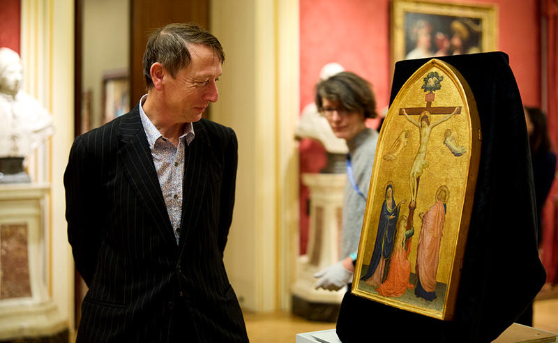 Director Xa Sturgis admiring the newly-acquired Fra Angelico painting of The Crucifixion at the press unveiling on the day it arrived at the Museum -