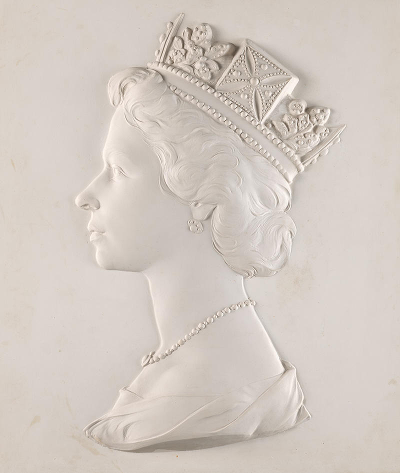 A version of the ‘Dressed Head’ sculpture of Queen Elizabeth II, Arnold Machin, 1966, plaster relief © The Postal Museum A white plaster relief 'dressed head' bust of Queen Elizabeth II - used on billions of postage stamps